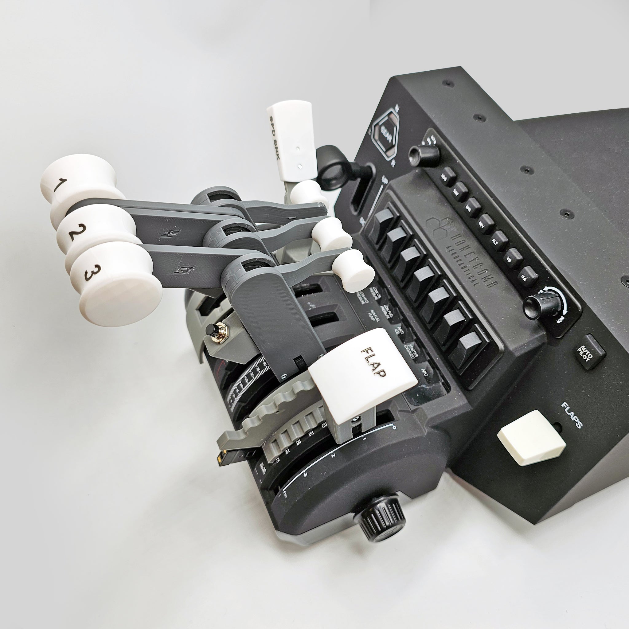 Close-up of the ProDeskSim Classic Boeing 727 Advanced Full Package Addon/Modification for Honeycomb Bravo and Flight simulator, showcasing a throttle quadrant with labeled levers numbered 1, 2, and 3. This device includes switches, knobs, and a flap control to deliver an authentic flight simulation experience against a light gray background.