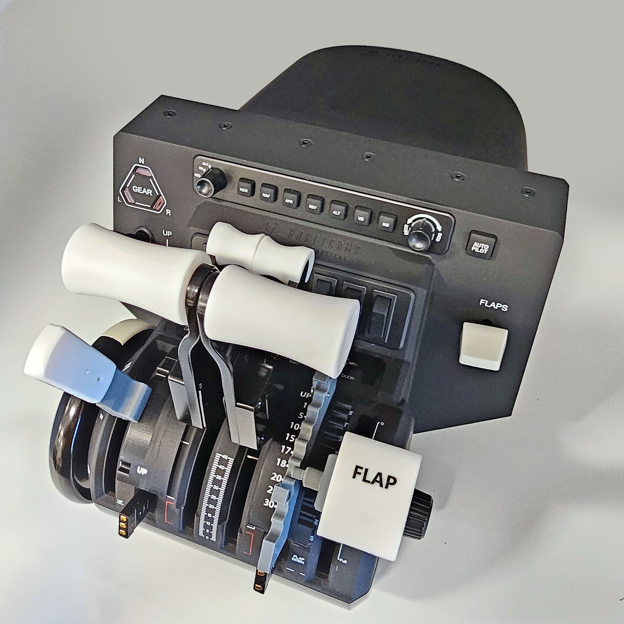Close-up of a flight simulator throttle quadrant featuring the Prodesksim Boeing 787-8/9/10 Professional addon for the HoneyComb Bravo. This addon includes multiple levers and switches for gear, flaps, and throttle controls. The dual action design incorporates black and white elements, a digital display, and industry-standard roller detent buttons for realistic simulated aircraft operations with its Detent/Spring mechanism flaps.