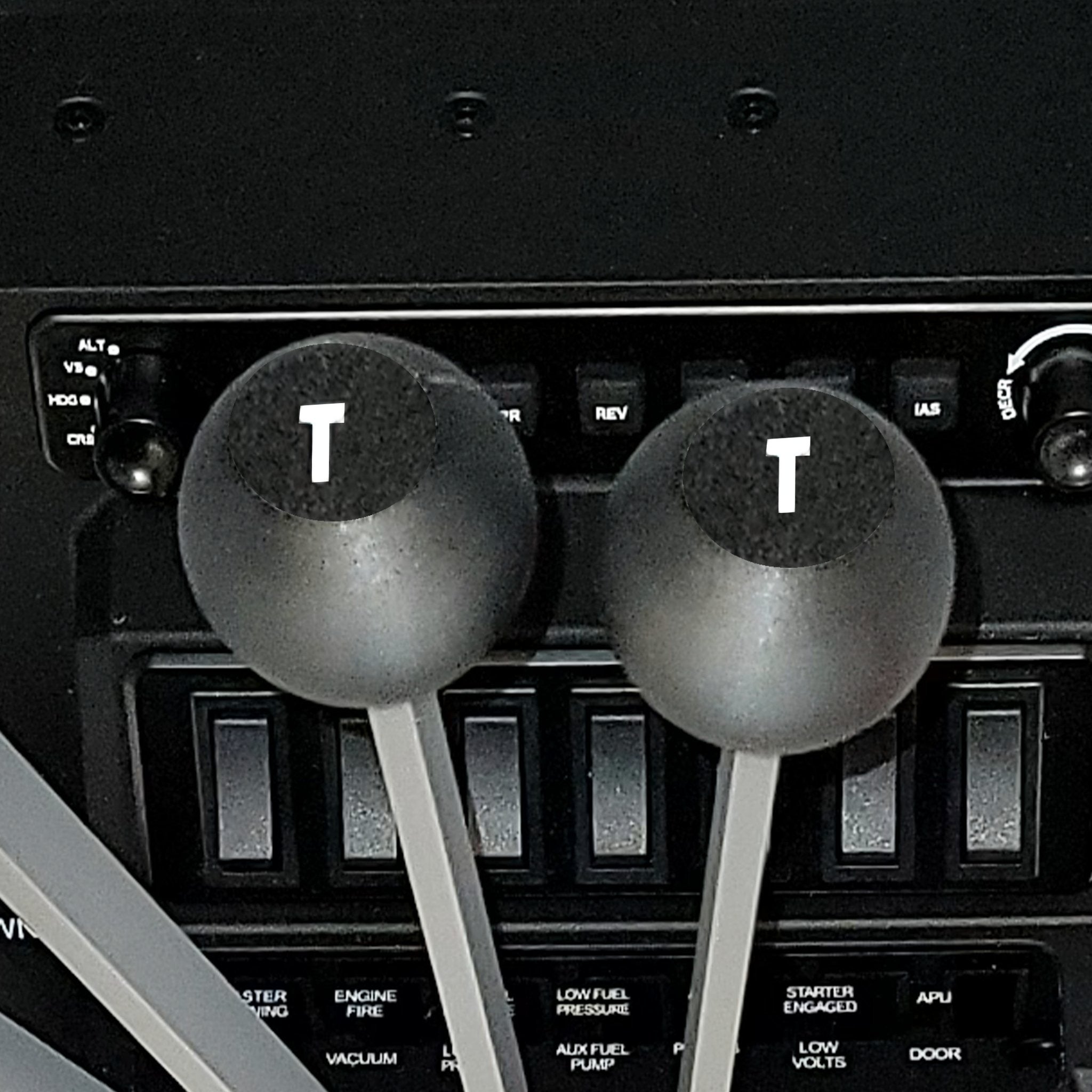 Close-up of the Prodesksim DC-3 set of 6 Levers Addon for Honeycomb Bravo Throttle Quadrant, featuring cockpit throttle levers labeled "T" on top. Surrounded by switches and panels with labels like "ALT" and "IAS," these levers, including 2X throttle, 2X mixture, and 2X props, are crucial components of flight control instrumentation for a DC3 Twin Engine.