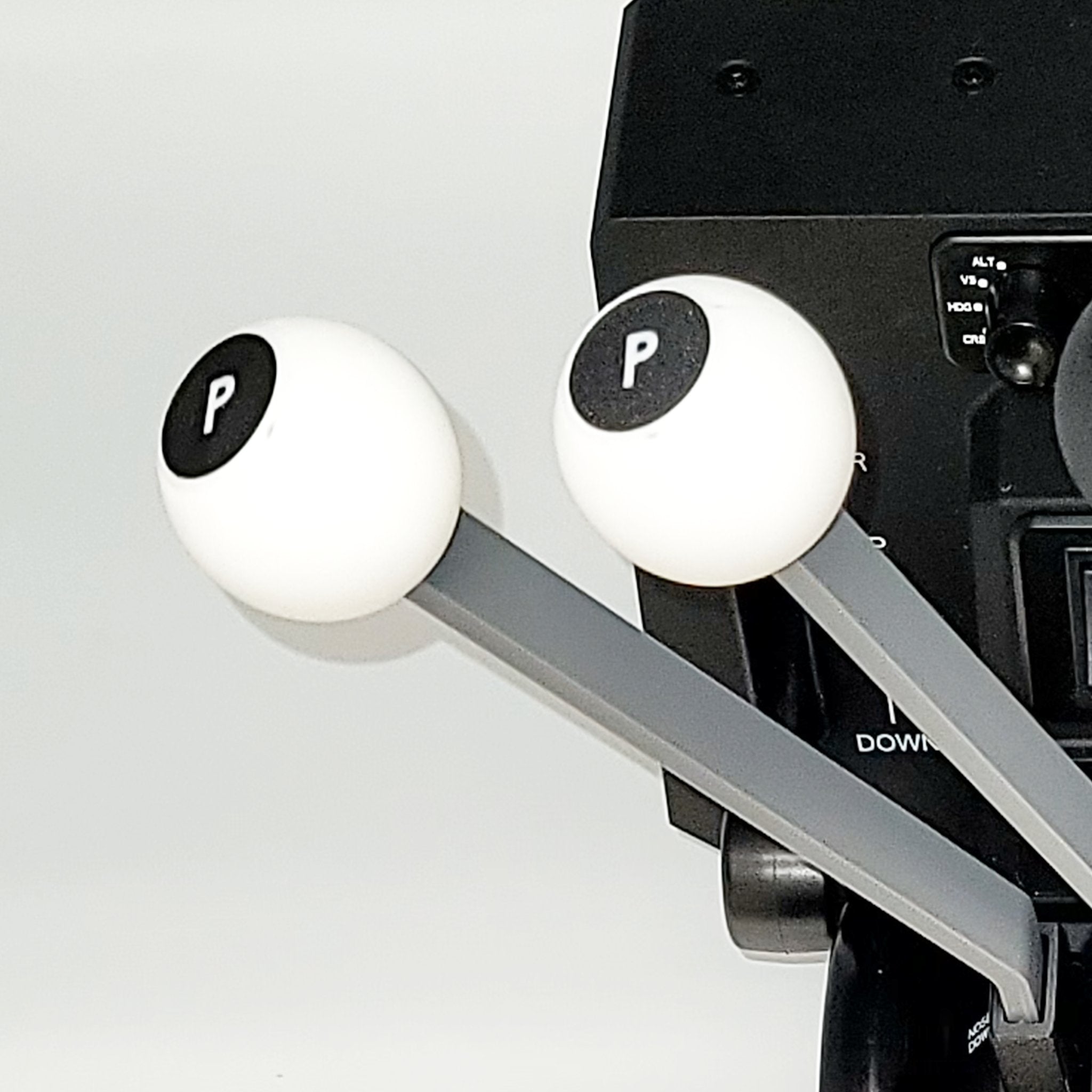 Close-up of two white levers with black "P" labels, part of the Prodesksim DC-3 set of 6 Levers Addon for Honeycomb Bravo Throttle Quadrant. The levers feature long gray handles and are set against a black background with additional controls and text partially visible, reminiscent of a DC-3 Twin Engine control panel.