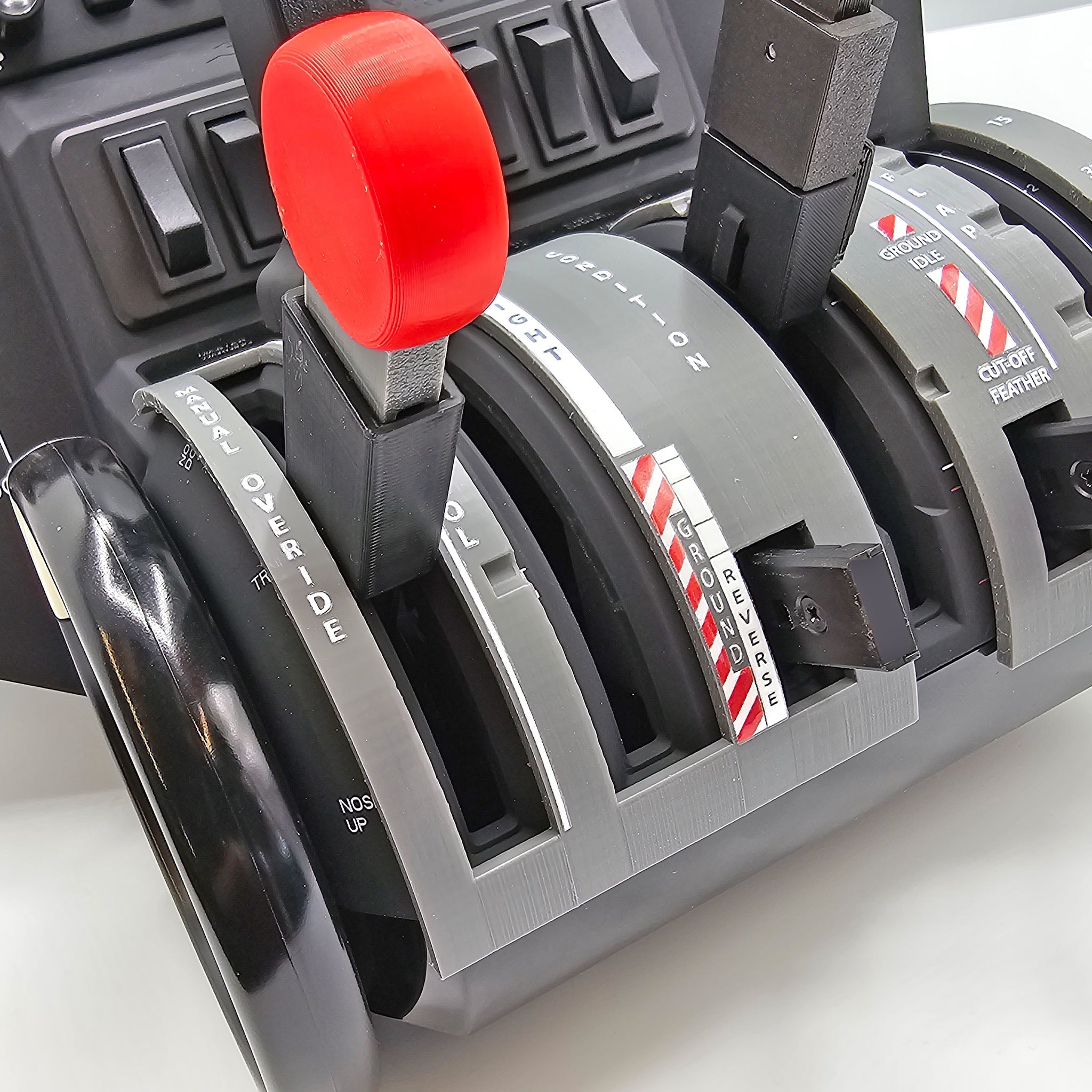 A detailed view of the NEW! ProDeskSim Pilatus PC-12 Addon/Mod package for the Honeycomb Bravo Throttle Quadrant reveals multiple levers marked "Throttle," "Propeller," and "Fuel." Manufactured by Prodesksim, these levers are positioned at various angles and incorporate switches and buttons that emulate the control functions of a Pilatus PC-12.