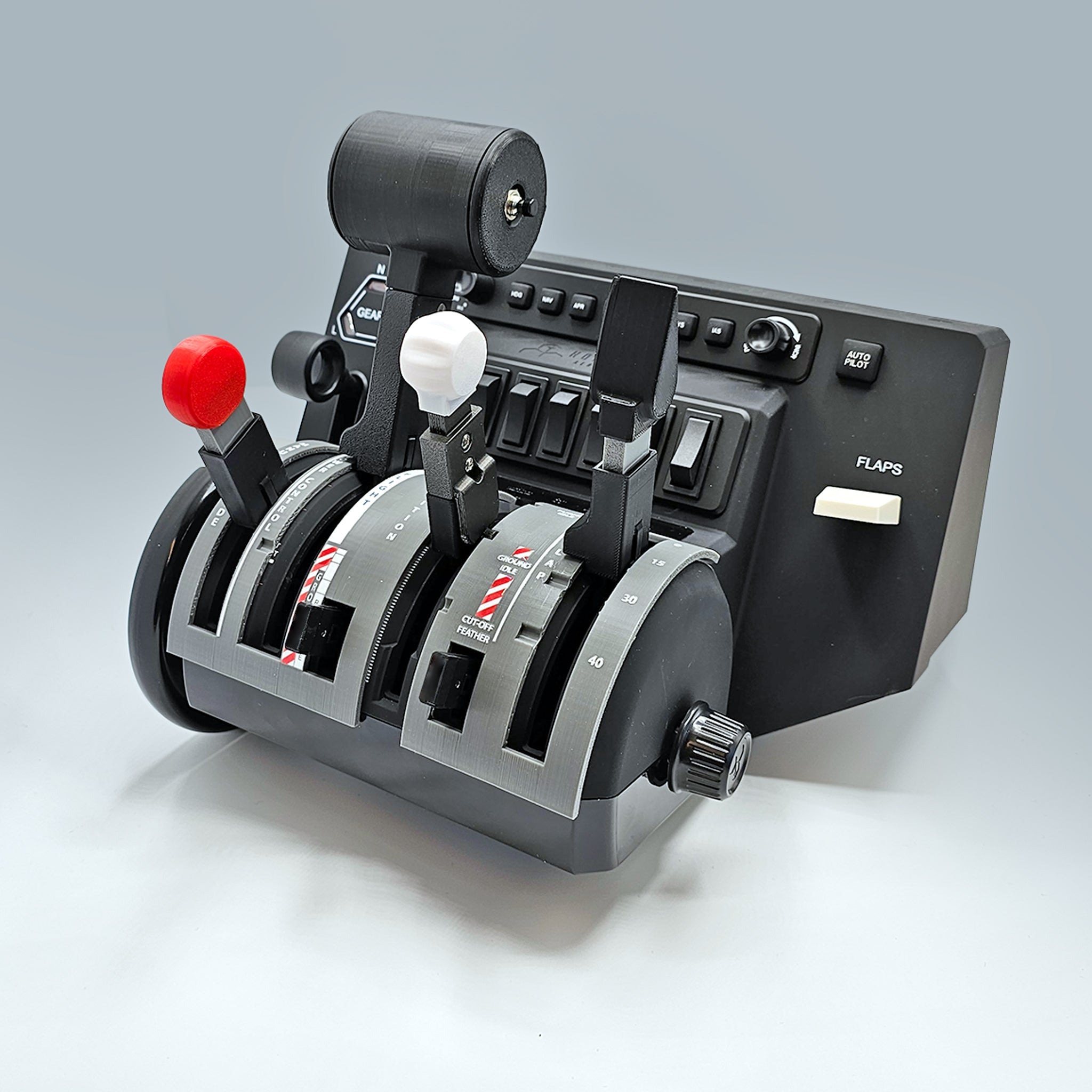 A close-up photo showcases the ProDeskSim Pilatus PC-12 Addon/Mod package, designed to perfect your flight simulation setup with the Honeycomb Bravo Throttle Quadrant. This addon features three lever controls with labeled positions, buttons, and switches, displaying red and white handles against a plain gray background.