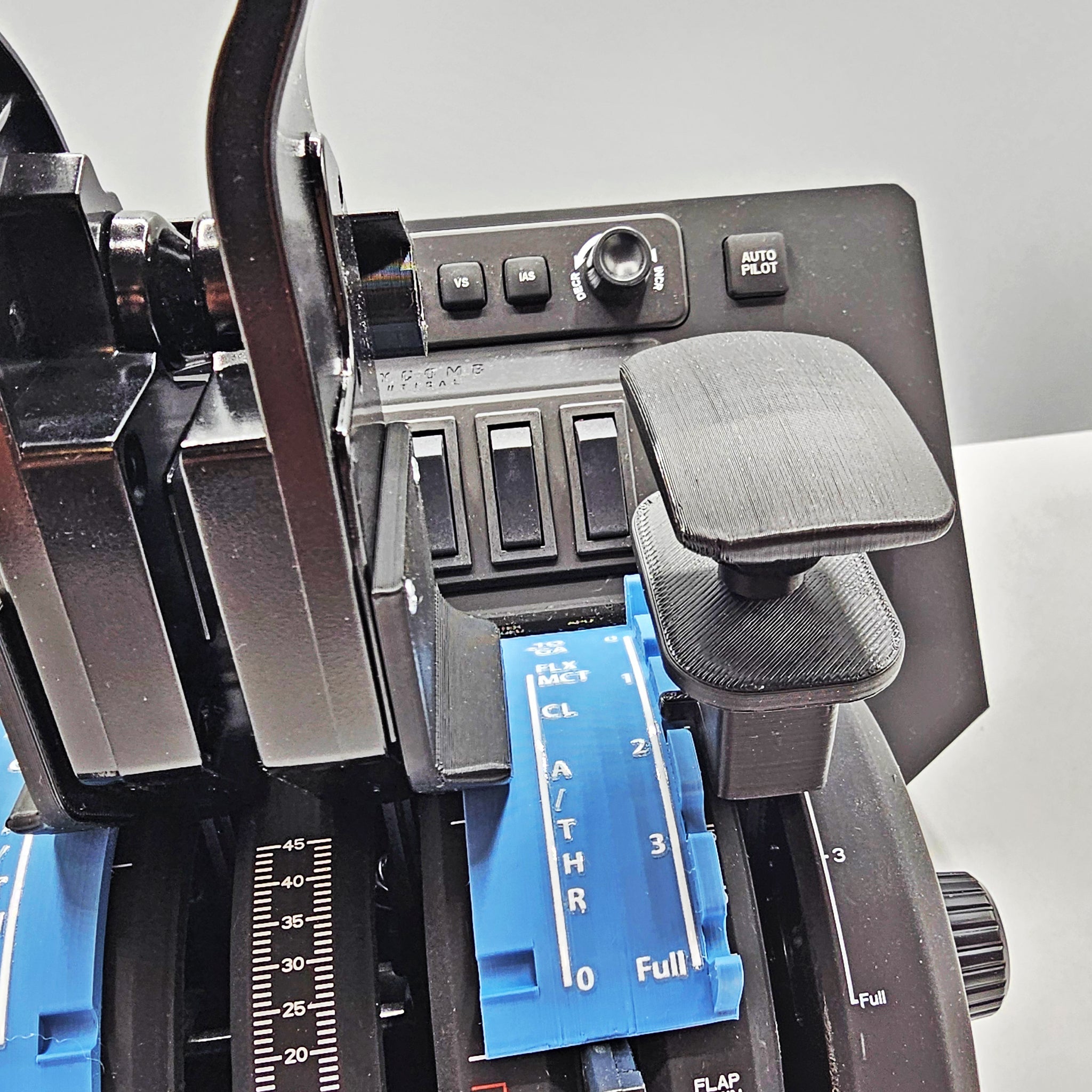 Close-up of the Prodesksim Airbus A319-320-321 Dual Action Addon for the Honeycomb Bravo throttle quadrant, showcasing blue levers labeled "AIR THRO" and various black switches and buttons, including an "AUTO PILOT" button, enhancing the flight simulation experience against a light background.