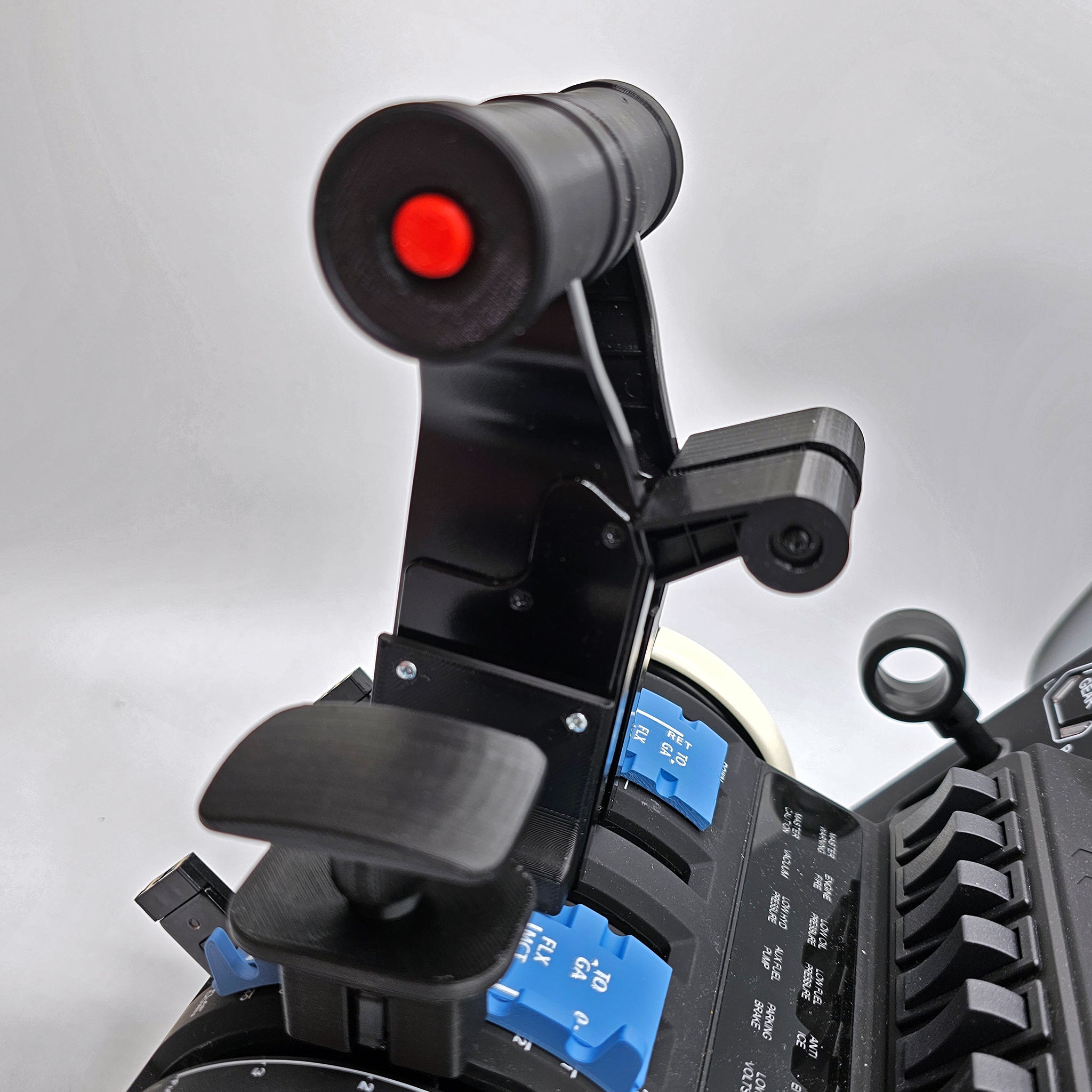 A detailed view of a Prodesksim Airbus A319-320-321 Dual Action Addon for the Honeycomb Bravo throttle quadrant, featuring a black design with a distinct red circular component and adjustable parts. It is installed on a panel filled with various buttons and switches, some highlighted in blue, elevating the flight simulation experience against a white background.