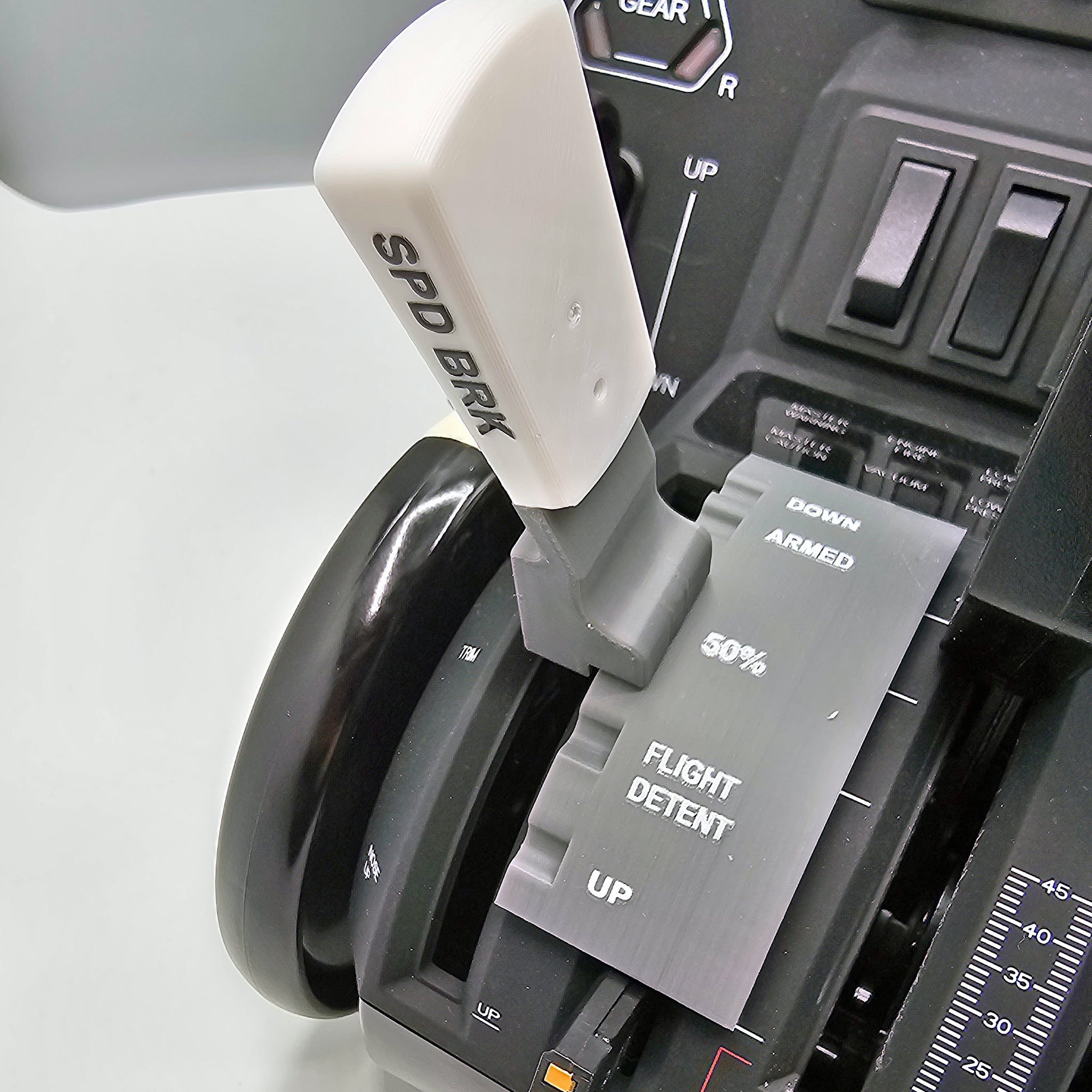 Close-up of the Boeing 737 Dual Action Detent/Spring mechanism flaps with a realistic speed brake lever labeled "SPD BRK." Created by Prodesksim as a professional addon for the HoneyComb Bravo throttle/VR system, this white lever is situated near switches labeled "DOWN" and "ARMED," alongside a percentage scale for flight settings against the control panel.