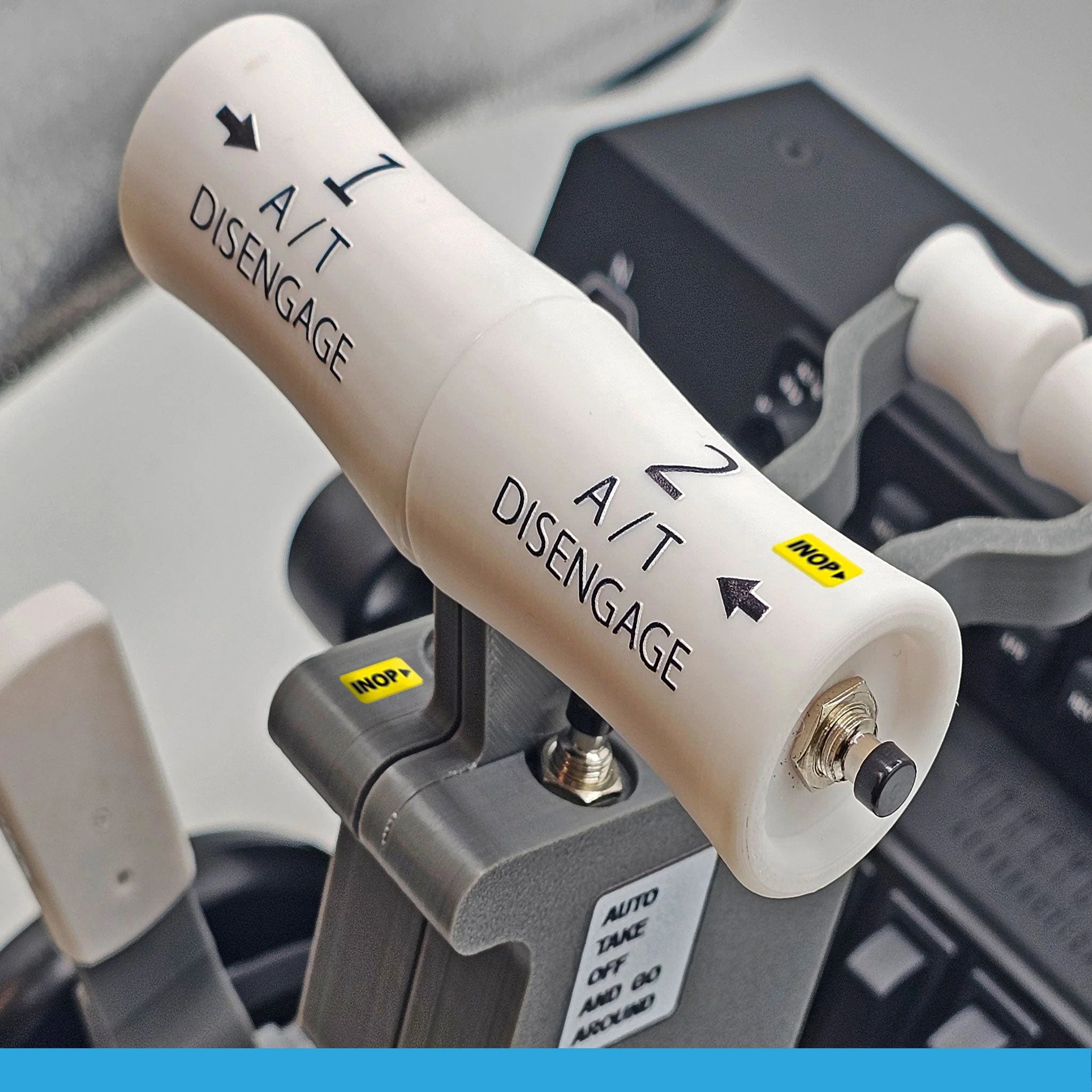 A close-up of the ProDeskSim Boeing 737 Advanced Full Package Addon/Modification for the Honeycomb Bravo throttle quadrant highlights two white levers marked "A/T Disengage" with arrows. An "INOP" sticker and a small switch labeled "AUTO THROTTLE DISENGAGE" are present, bringing to mind a flight simulation experience. The background is detailed with control panel elements.