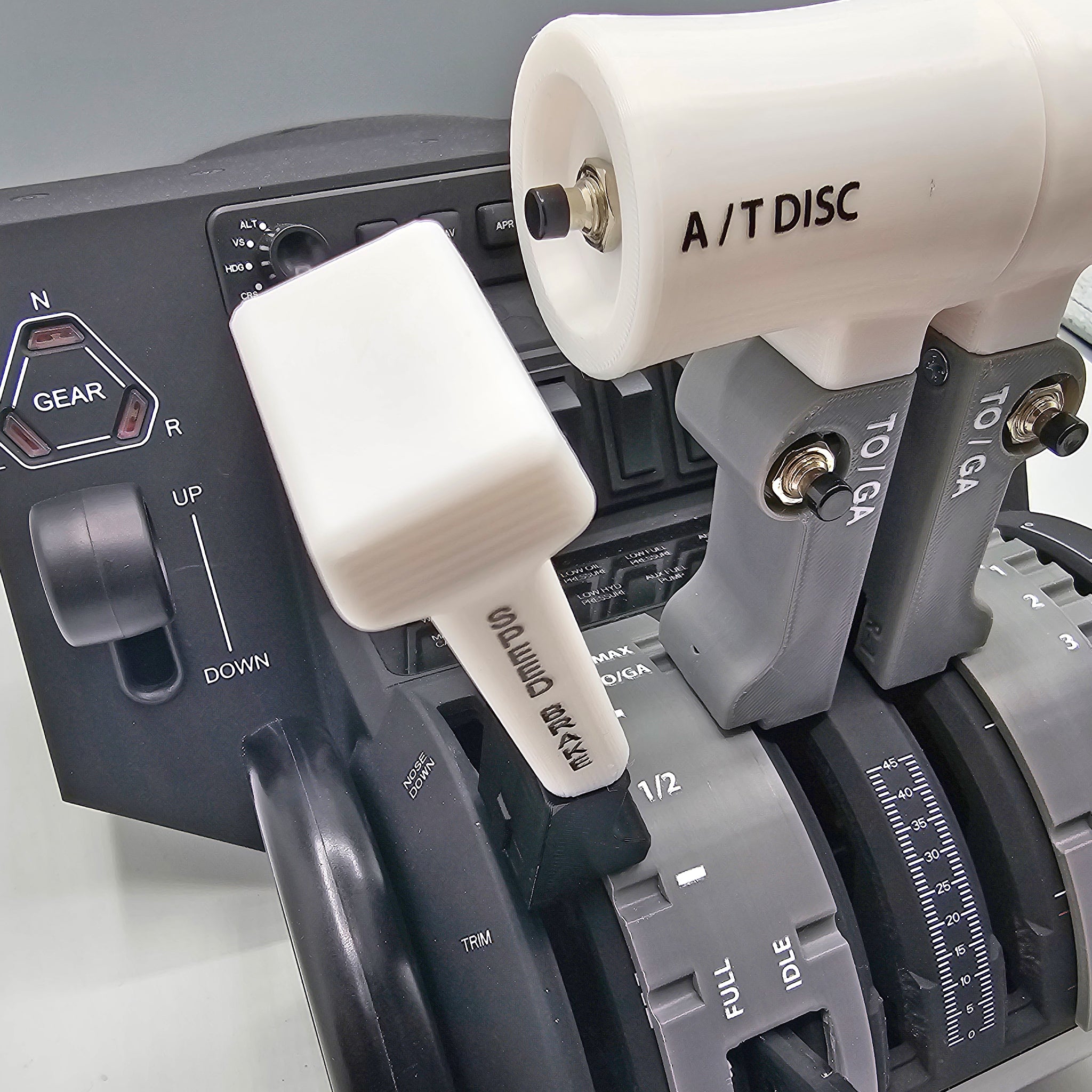 A close-up image features multiple levers labeled A/T DISC, TO/GA, and GEAR on an E-jet family aircraft throttle quadrant with settings for L. Half, Full, and R. In the background is the NEW! ProDeskSim Honeycomb Bravo addon for the E-jet series from Prodesksim, offering gear adjustment options that are perfect for flight simulation enthusiasts.