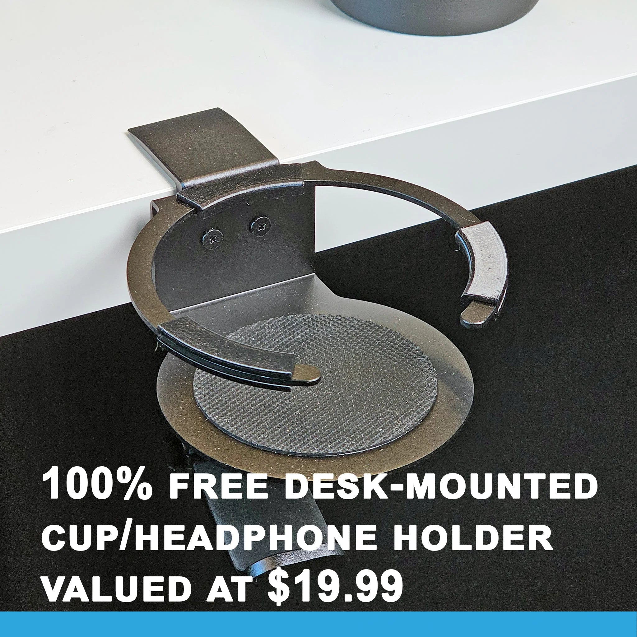 A black G58 Baron - The Cup Holder Flight Fidget from FlightFidgets.com attaches to the edge of a white desk, perfect for airplane enthusiasts. Text reads "100% Free Desk-Mounted Cup/Headphone Holder Valued at $19.99," making it an ideal fidgeting gadget for those on long flights.