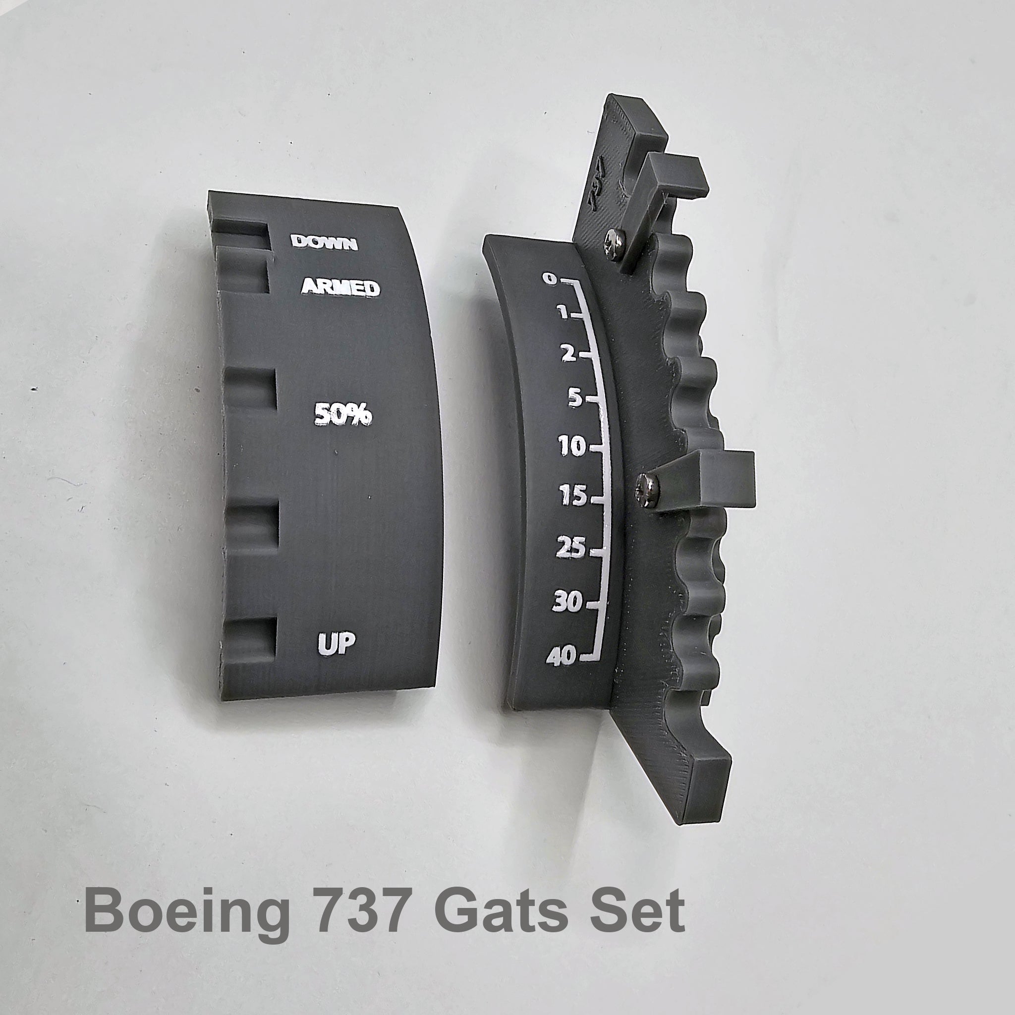 Two black curved components labeled "DOWN," "ARMED," and "UP," featuring a percentage indicator and a scale from 0-40, rest on a flat surface. Text below reads, "Boeing 737 Gats Set." The ProDeskSim Advanced dual action gates and speed brake detent track from Prodesksim is designed to illustrate the flaps systems crucial for simulating flight dynamics.