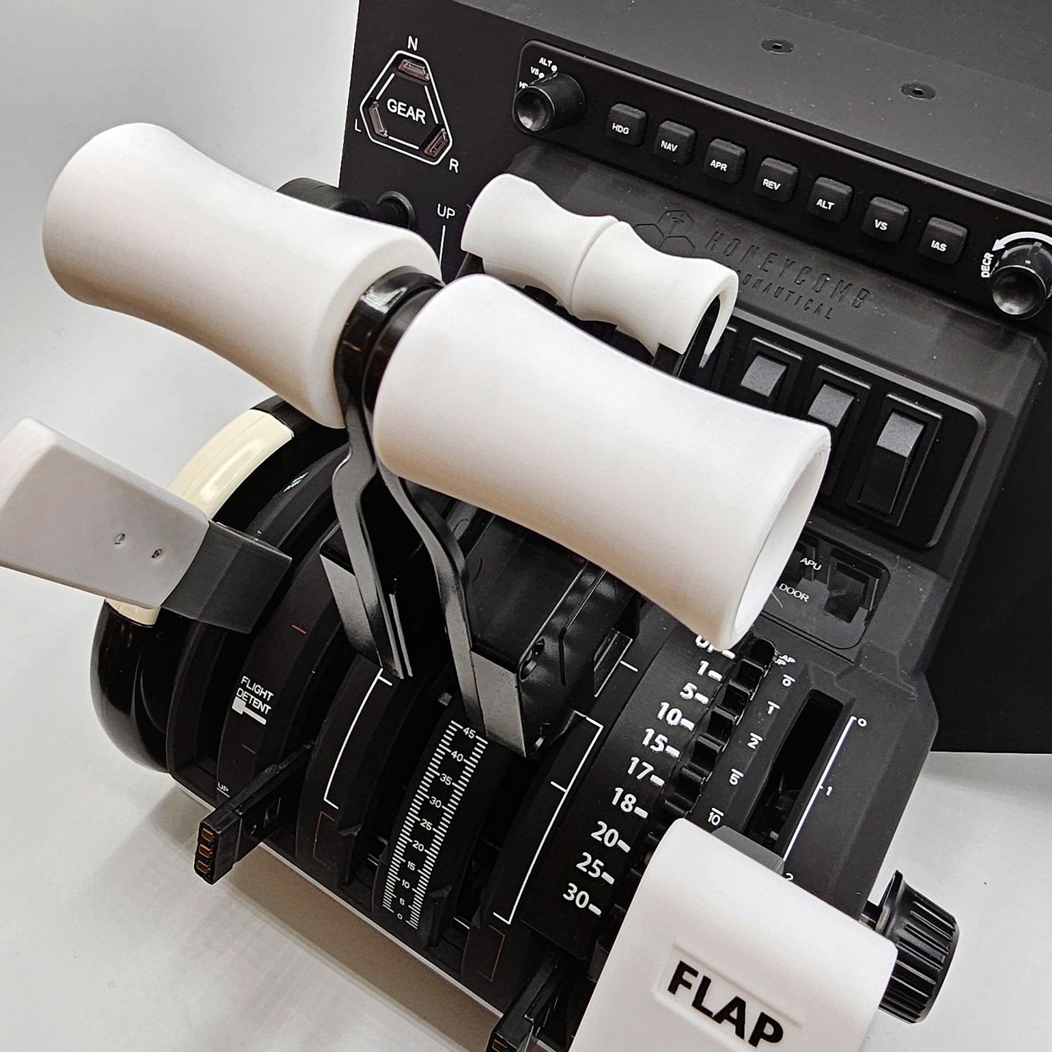 Close-up of the Prodesksim Boeing 787-8/9/10 Base Realistic and Professional Base package for the Honeycomb Bravo, featuring white levers, a black base, and detailed labels like "GEAR" and "FLAP." This advanced setup, perfect for flight simulation enthusiasts, includes gear shift controls with spring-loaded flaps and Boeing 787 flap functions.