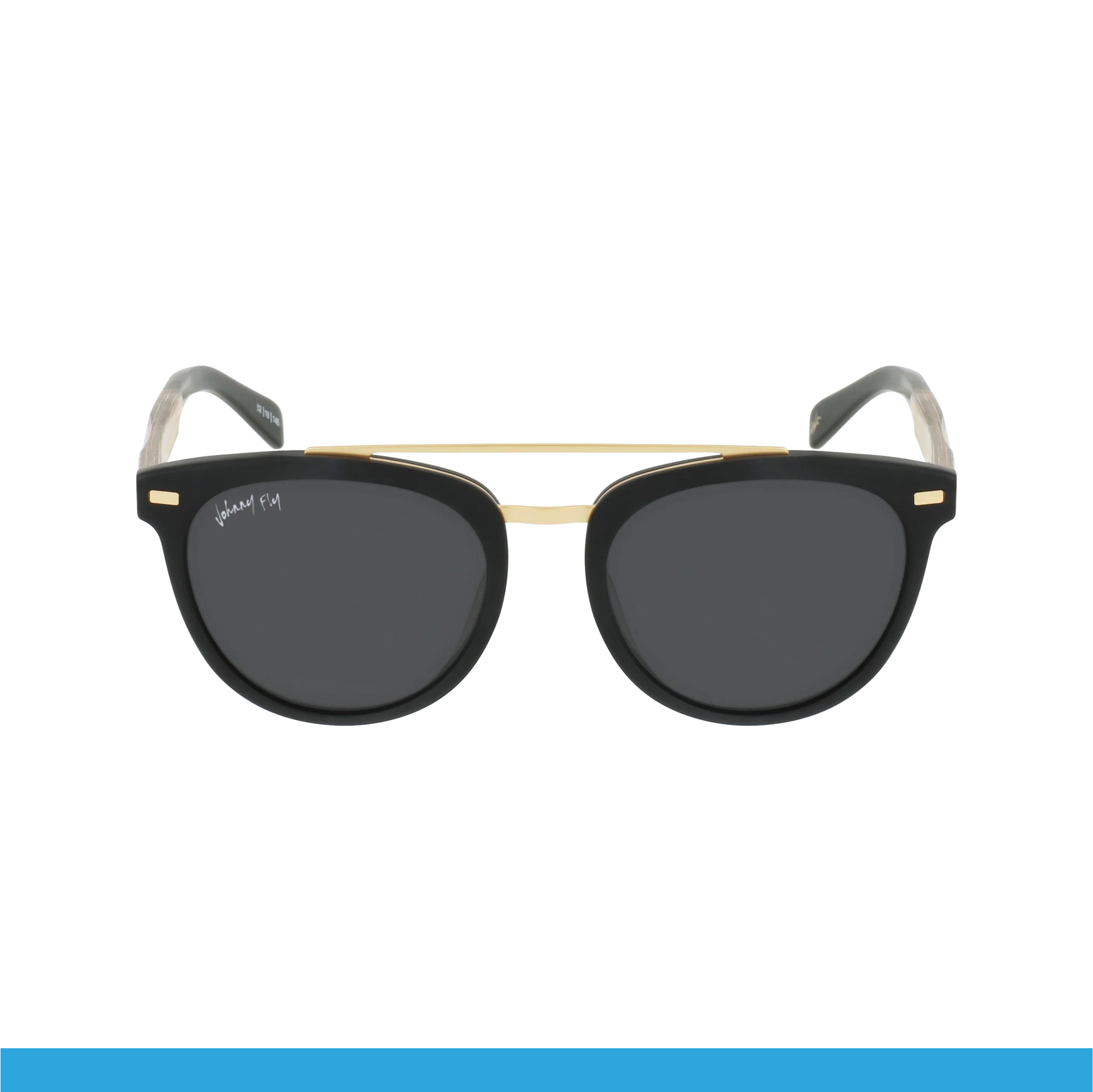 Introducing the "Captain" by Johnny Fly: These stylish black sunglasses feature round dark lenses and a sleek acetate front section, enhanced with a golden bridge. The white temple tips boast a signature on the upper corner of the right lens. Set against a plain black background, they elevate any look effortlessly.