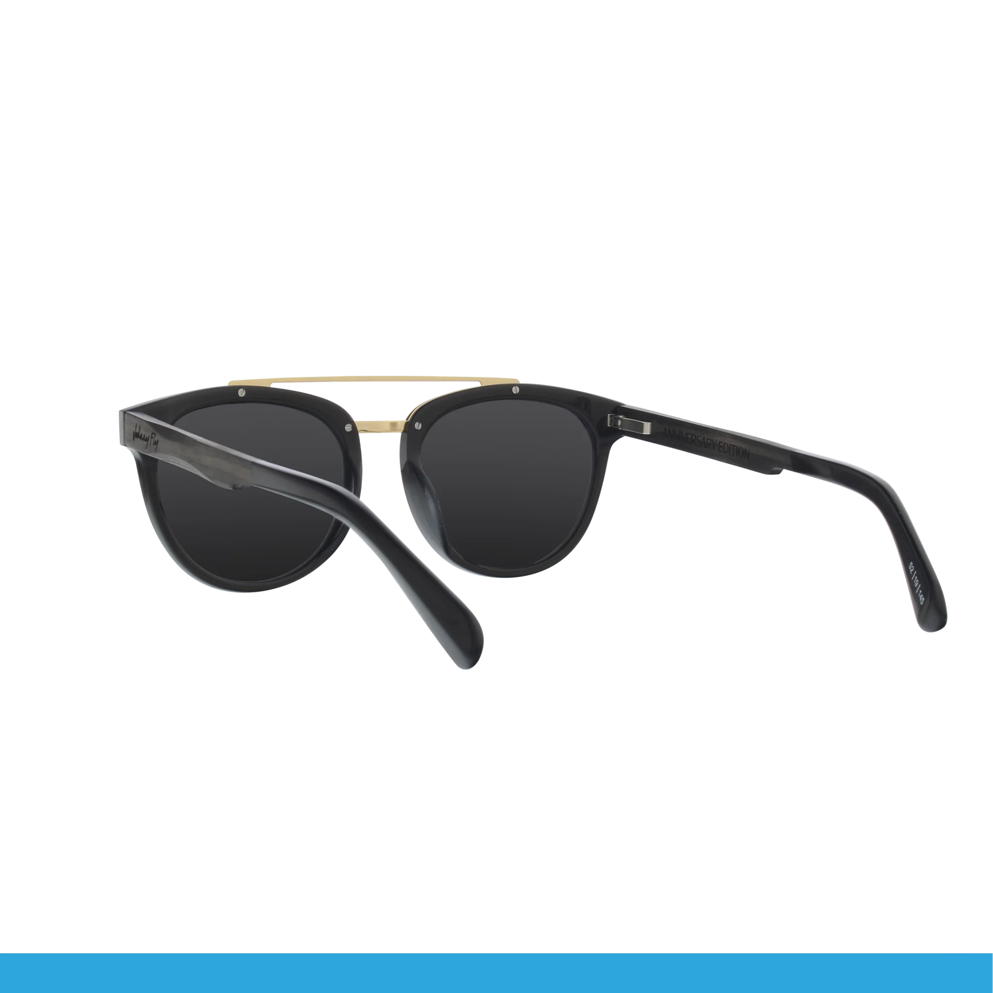 Introducing the Captain sunglasses by Johnny Fly, showcasing a stylish design with dark, polarized lenses set in a sleek black frame. These sunglasses feature a minimalist aesthetic highlighted by a thin gold bridge connecting the lenses. The elegantly crafted wooden arms are slightly curved to ensure a comfortable fit.