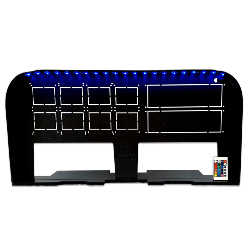 The Flight Velocity Pro Series Model 2 - FVPro2, crafted by Flight Velocity, is a black display stand designed to elevate your flight simulation experience. It features multiple rectangular cutouts arranged in rows, with blue LED lights illuminating the top edge. A small remote control is placed in front of it, making it an ideal choice for users of Honeycomb Alpha Yoke accessories.