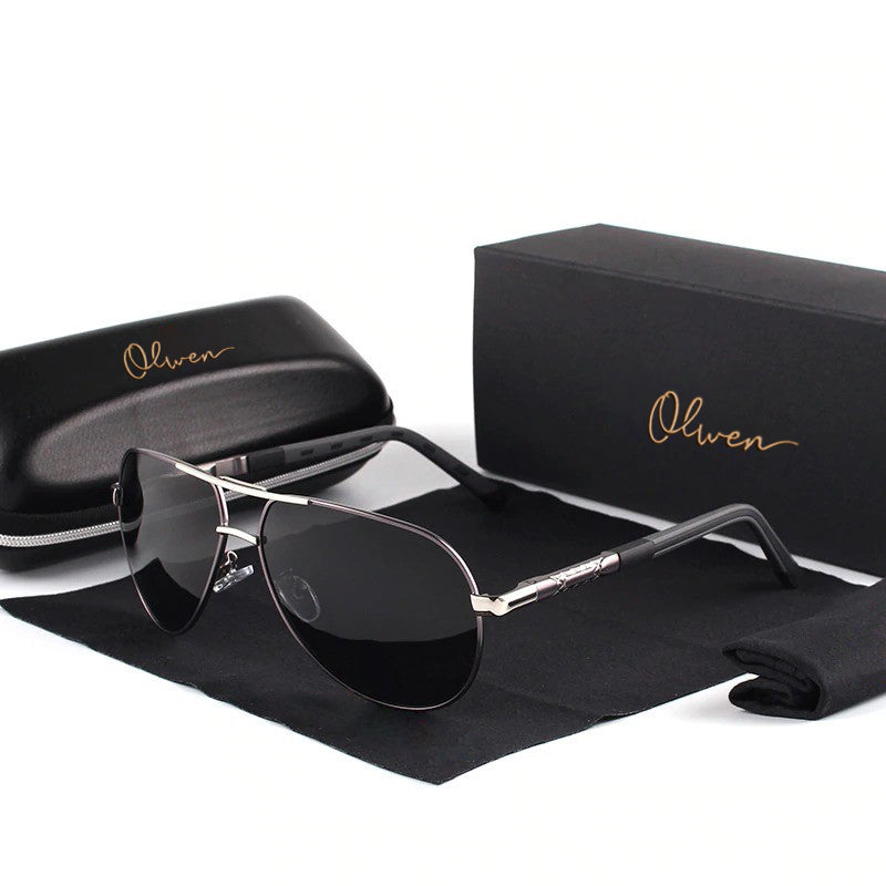 A pair of Polarized XL/XXL Aviator Sunglasses for Large Heads is placed on a black cleaning cloth, with a matching case and box featuring the gold "Olwen" logo in the background.