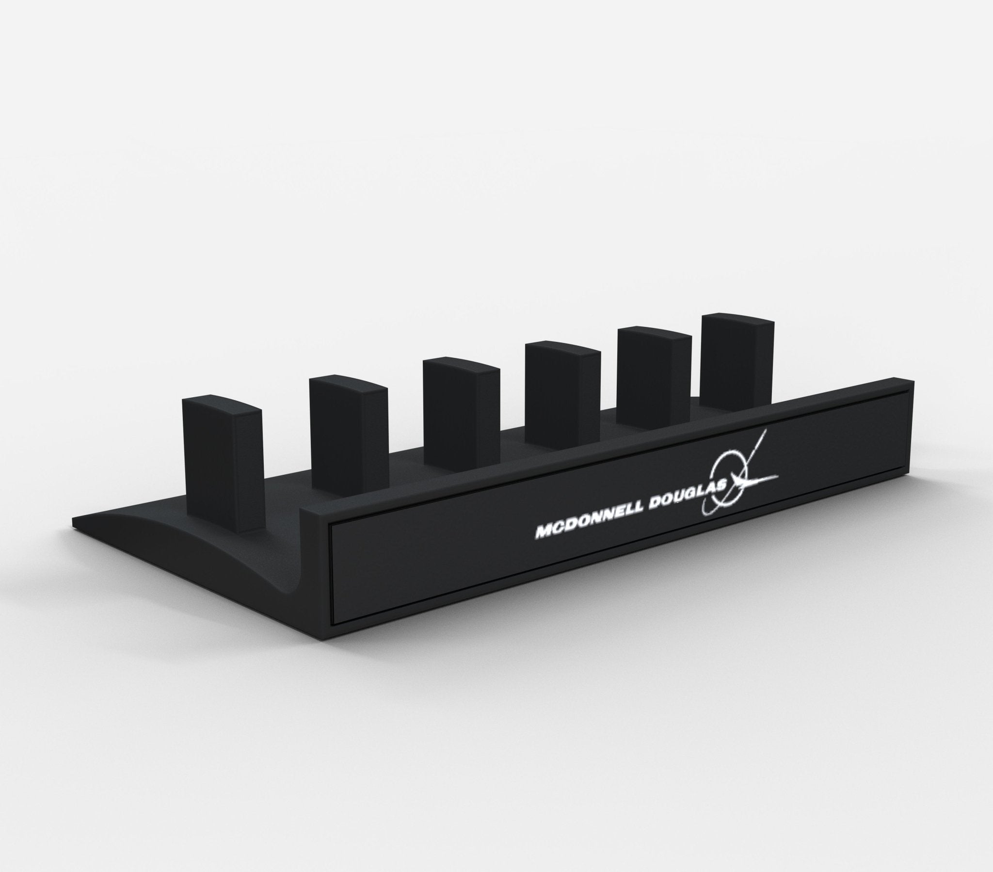 A sleek black Honeycomb Bravo Add-on ORGANZISER by Prodesksim, featuring five rectangular slots adorned with the McDonnell Douglas aircraft logo on the front. This minimalist stand for handles and levers boasts a smooth finish and a modern aesthetic, echoing the style of ProDeskSim products.