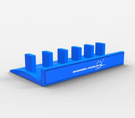 The Prodesksim Honeycomb Bravo Add-on Organizer is a sleek blue plastic stand with six square slots, featuring "McDonnell Douglas" and an aircraft logo on the side. It is perfect for displaying Honeycomb Bravo levers or ProDeskSim handles, combining functionality with an elegant design.