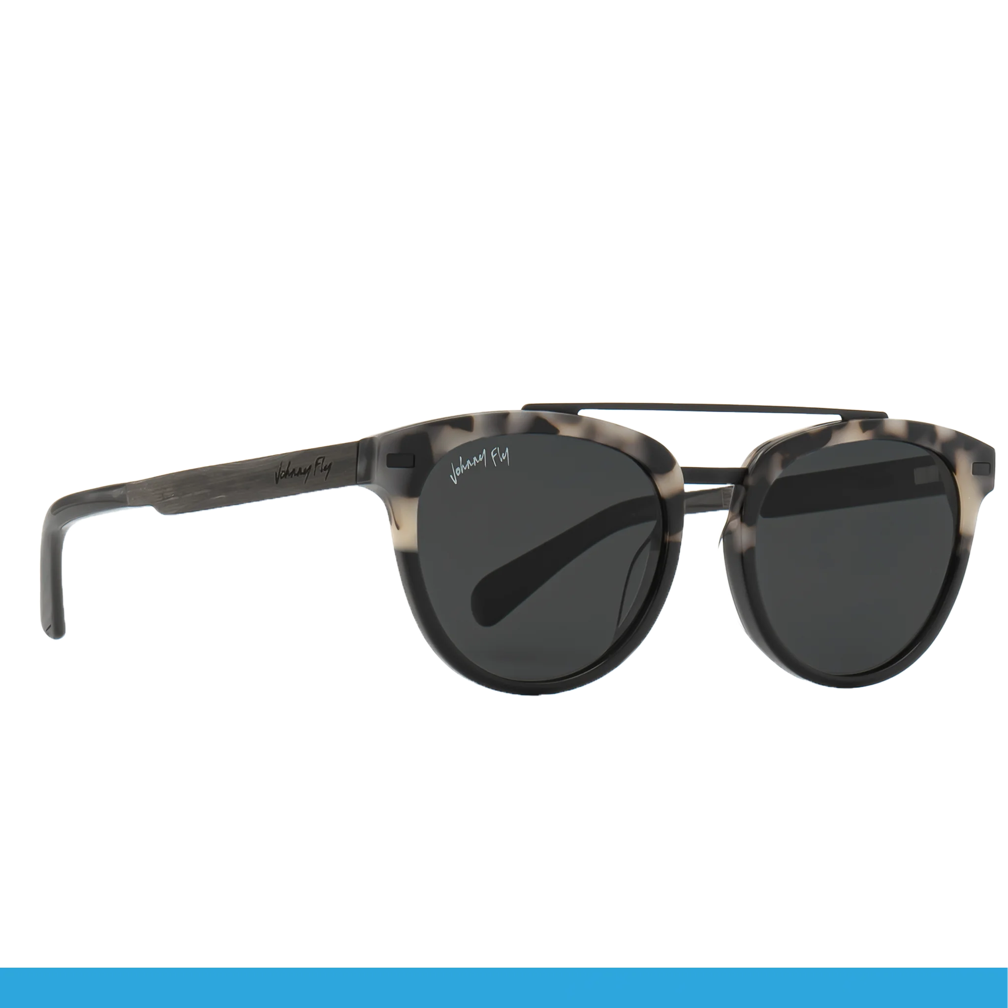 Discover the unique style of the Captain sunglasses from Johnny Fly, featuring round, polarized dark lenses and a striking tortoiseshell frame. The brand name is elegantly displayed on one arm, while wooden arms add an exceptional touch of flair.