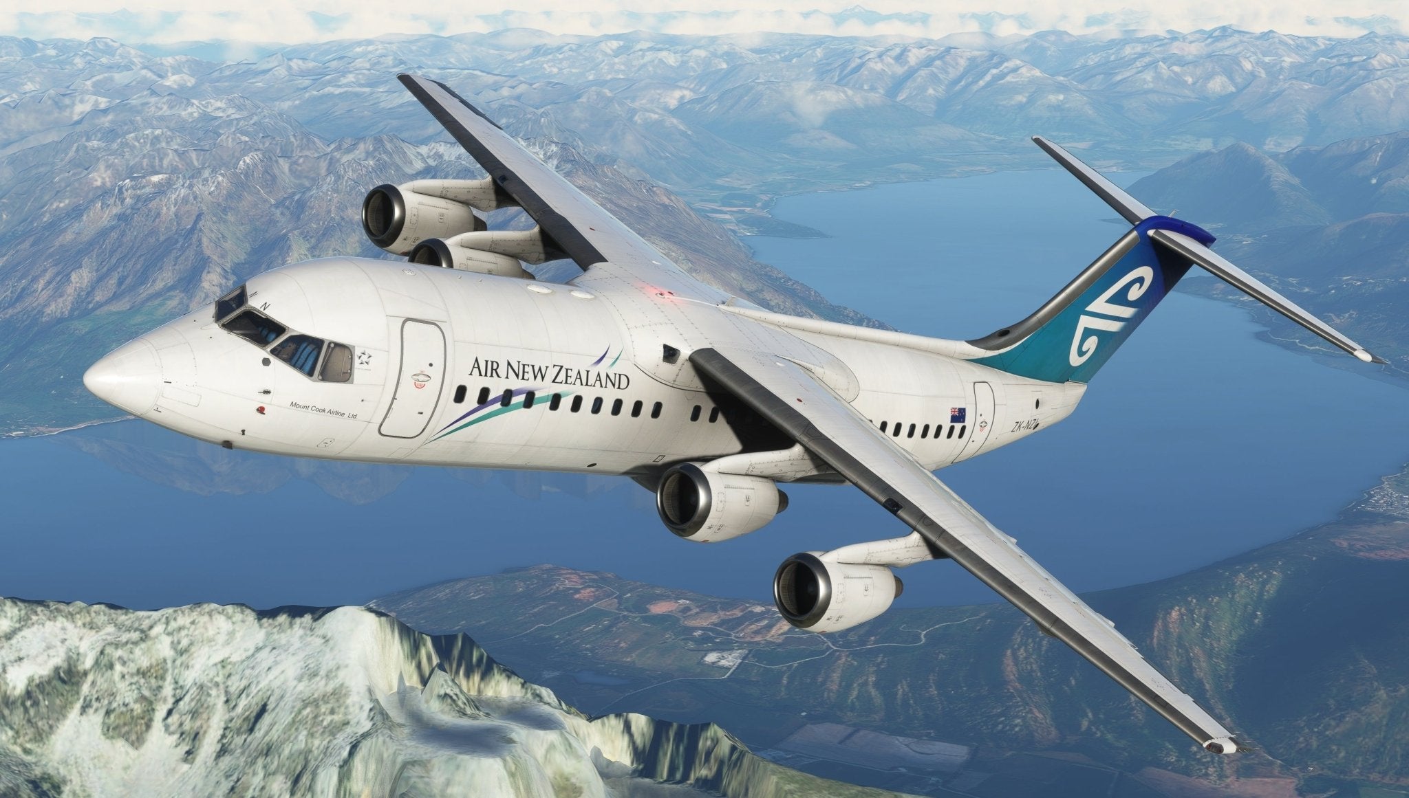 A white Air New Zealand airplane, reminiscent of the Just Flight BAE-146 Professional for MSFS2020, soars gracefully above a scenic landscape. Below, mountains cradle a serene lake amid lush greenery. The clear sky is dotted with scattered clouds as the MSFS-rendered aircraft glides from an angled view.