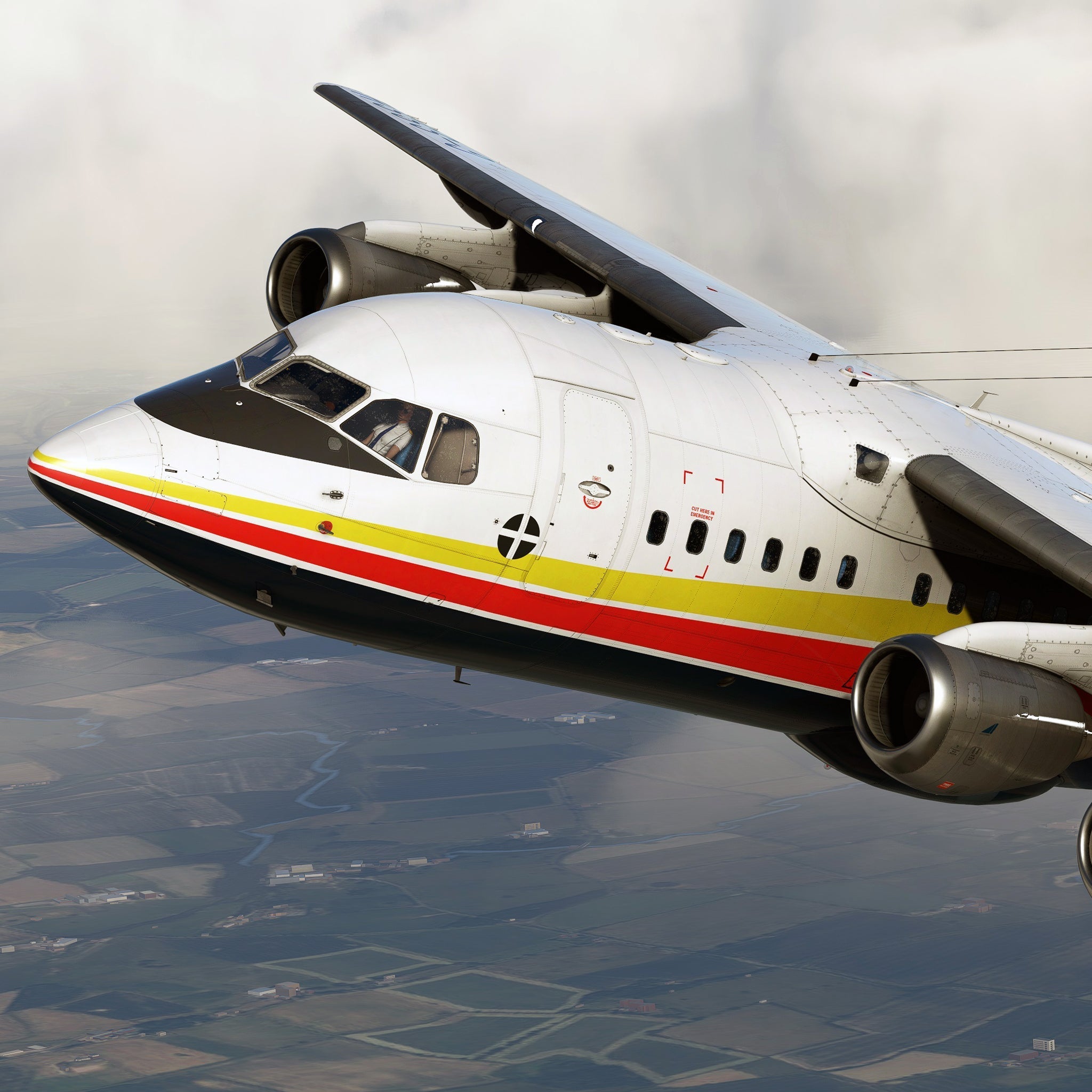 A close-up of a white and gray plane with red and yellow stripes, resembling the Just Flight BAE-146 Professional for MSFS2020, soaring over a landscape with fields. The plane is angled as it turns, featuring clouds in the background and a visible cockpit window.