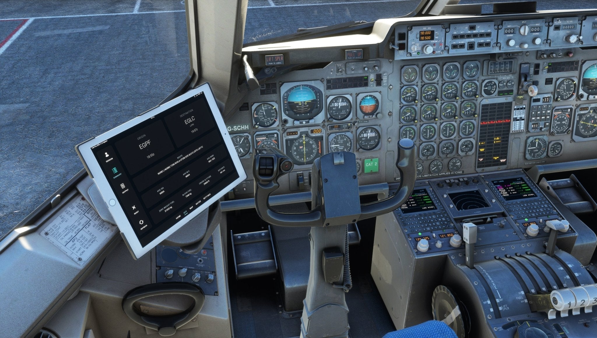 The cockpit of an aircraft, akin to the Just Flight BAE-146 Professional for MSFS2020, features an extensive array of control panels, switches, and gauges. A tablet is mounted on the left side, providing technical information essential for MSFS enthusiasts. The well-lit scene emphasizes the detailed instrumentation and pilot seat.