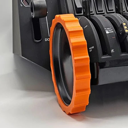 A close-up of the Prodesksim 1 Color Vibrant and Flexible Trim Wheel Cover for the Honeycomb Bravo Throttle Quadrant shows an orange, gear-like trim around the throttle lever. Perfect for flight simulation, this black device features various switches and labels visible in the background.