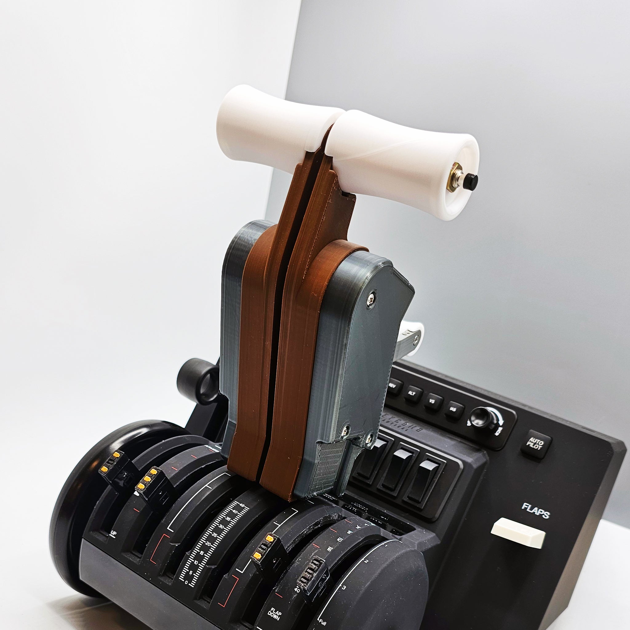 A close-up view of the ProDeskSim Boeing 777 Advanced Full Package Addon for Honeycomb Bravo and Flight Simulator, showcasing multiple levers, knobs, and switches. This sophisticated device from ProdeskSim combines a striking mix of black and brown elements to elevate your flight simulation experience against a neutral background.