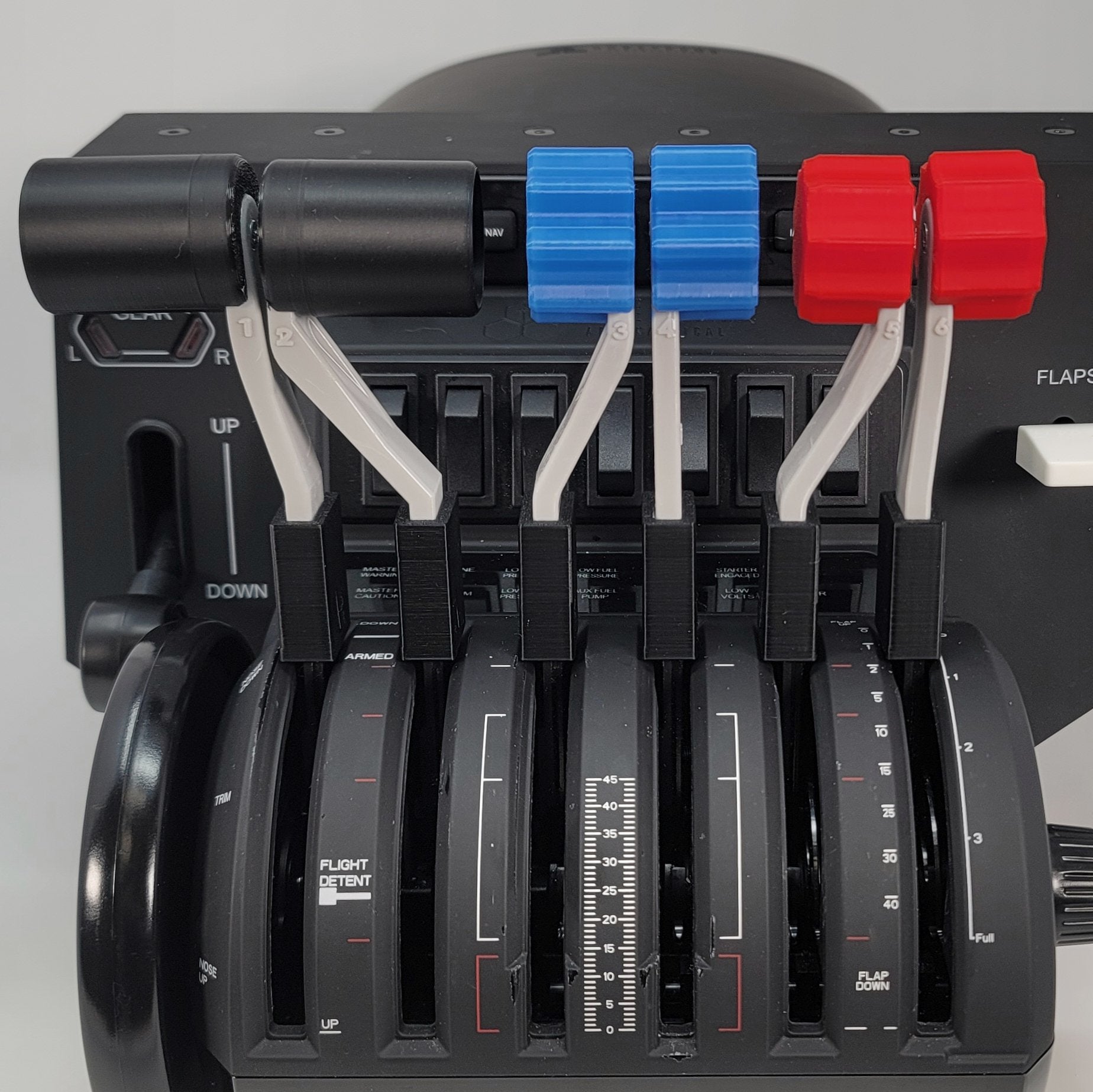 Close-up of an aircraft throttle quadrant featuring the Prodesksim Honeycomb Bravo G58 Baron Twin Engine Piston realistic throttle, fuel mixture, and prop pitch handles set. The black levers are adorned with red and blue handles, labeled for flight and engine controls against a dark control panel backdrop—perfect for upgrading your flight simulation experience.